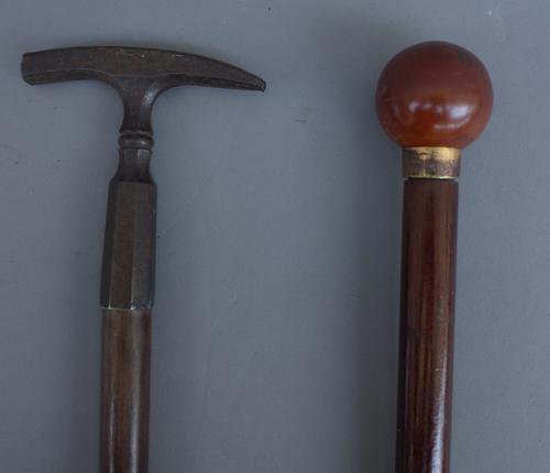 An early 20th century gadget cane with illuminating spherical pommel (91.5cm) and a mineralogist's walking stick, with steel 'hammer head' handle (91c