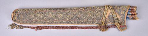 A Persian embroidered cloth quiver, early 19th century, foliate detailed with straps enclosing seventeen tipped wooden arrows, 66cm, with associated c