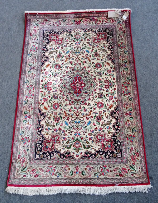 A silk Ghom rug, central Persia, stepped pistachio small medallion in a cream ground with allover floral decoration, 183cm x 122cm
