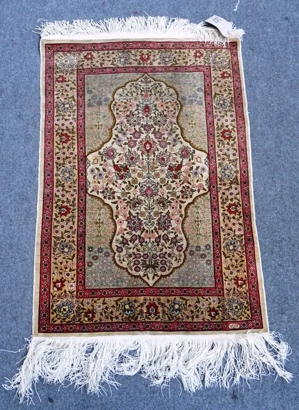 A silk Kayseri rug West Anatolia, stepped mirrored mihrab within pale green spandrels, allover floral decoration, 104cm x 75cm.