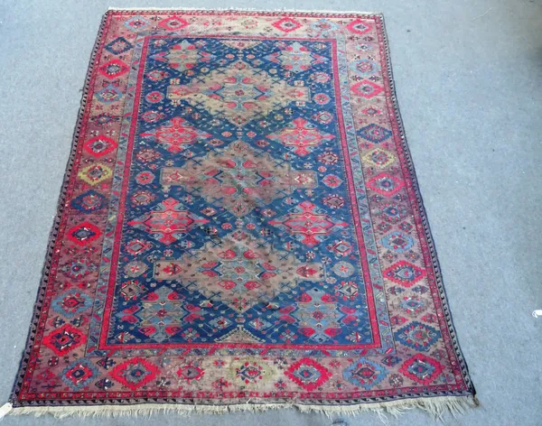 An antique Soumac carpet, the dark blue field with triple pole medallion, star and gul decorated main field, main border faded aubergine, approximatel