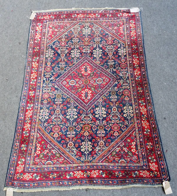 A Mahal rug, Persian, the indigo flower filled field with a similar madder diamond, matching spandrels, a madder trailing floral border, 223 x 131cm.