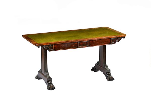 A William IV rosewood centre table, the rounded rectangular top on pair of frieze drawers on scroll slab trestle supports and four lions paw feet, 146