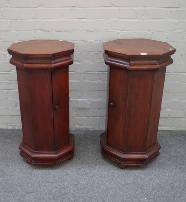 A pair of 20th century hardwood octagonal bedside tables on plinth bases, 45cm wide x 77cm high.