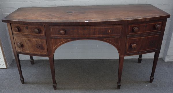 A George III inlaid mahogany bowfront sideboard, with pair of frieze drawers and swing out cellarette drawer, 181cm wide x 93cm high x 76cm deep.