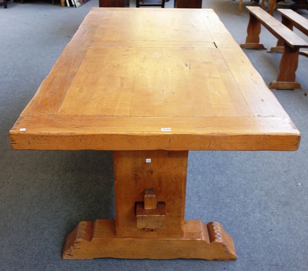 A thick set 20th century oak kitchen table, the cleated plank top on slab end supports, 100cm wide x 230cm long x 75cm high.