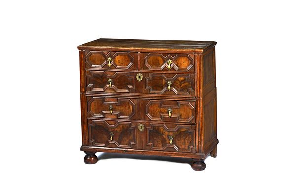 A Charles II walnut two part chest of two short and three long geometric doubled drawers on bun feet, 99cm wide x 93cm high x 53cm deep. Illustrated