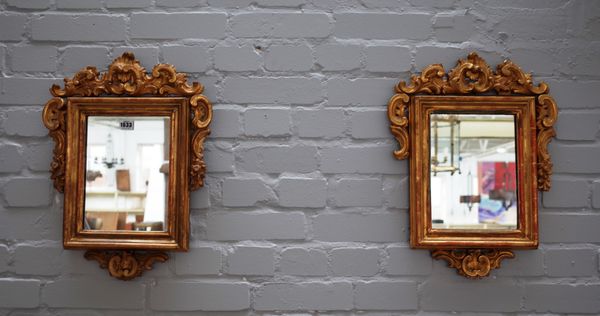 A pair of 19th century continental gilt framed wall mirrors with opposing 'C' scroll upper end lower frieze, 51cm high x 39cm wide (2).