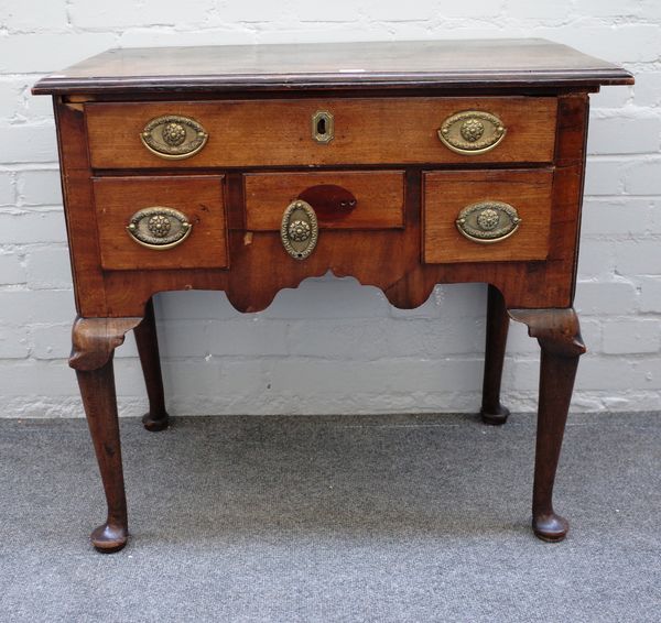 A mid-18th century walnut and mahogany lowboy with five frieze drawers on club supports, 76cm wide x 71cm high x 47cm deep.