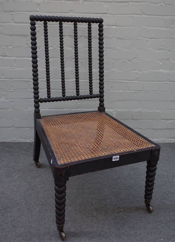 A Regency ebonised side chair with bobbin turned back, legs and cane seat, 51cm wide x 95cm high.