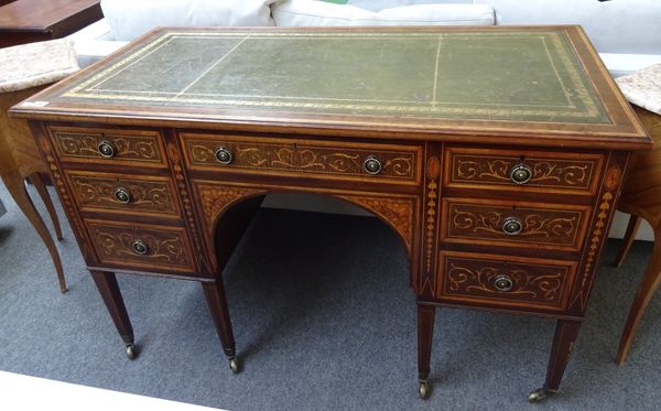 In the manner of Edwards & Roberts, a late 19th century marquetry inlaid mahogany writing desk with seven drawers about the arch knee, on tapering squ