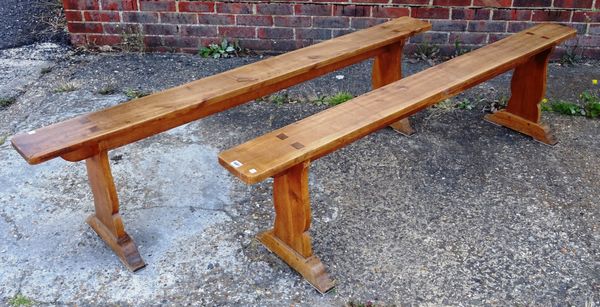 A pair of 19th century French fruitwood rectangular benches on silhouette trestle end supports, 185cm long x 48cm high x 17cm wide at top (2).