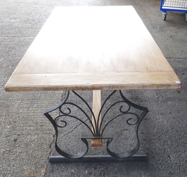 A 20th century dining table, the cleated bleached oak plank top on a wrought iron base, 90cm wide x 180cm long x 80cm high.