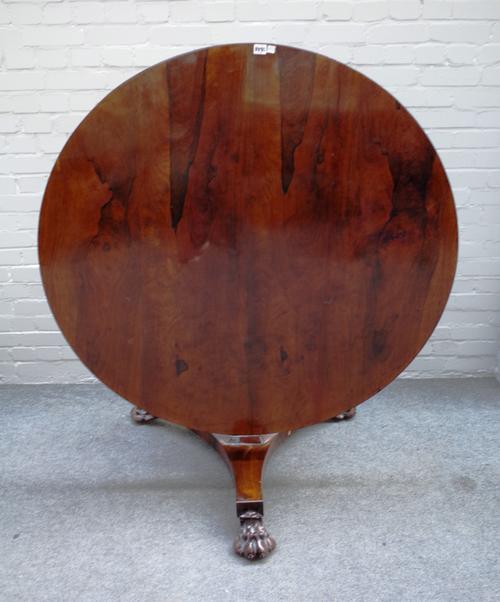 A Victorian rosewood centre table, the circular snap top on hexagonal column and three paw feet, 121cm diameter x 71cm high.