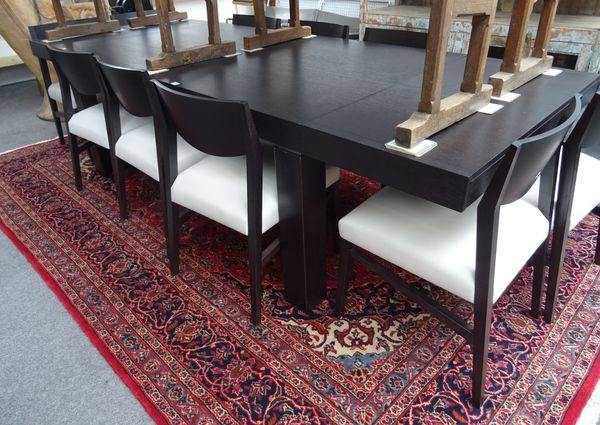 NATUZZI; a 20th century ebonised oak extending dining table, on triangular supports 105cm wide x 180cm long x 280cm long extended, together with ten m