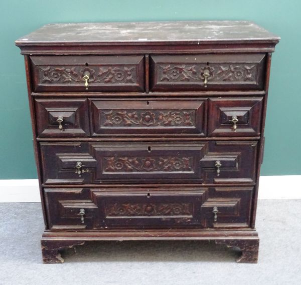 A Charles II and later carved oak and geometric moulded chest of two short over three long drawers on bracket feet, 101cm wide x 104cm high x 52cm dee