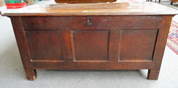 A 17th century oak coffer, the double plank top over triple panel front on stile feet, 122cm wide x 62cm high x 52cm deep.