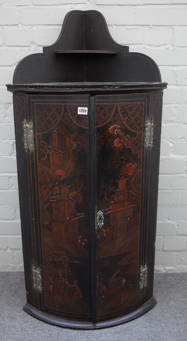 An 18th century black lacquer chinoiserie decorated bowfront hanging two door corner cupboard, 57cm wide x 119cm high.