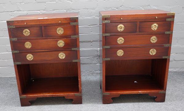 A pair of campaign style brass bound mahogany bedside tables each with brushing slide and two short and two long graduated drawers on recess bracket f