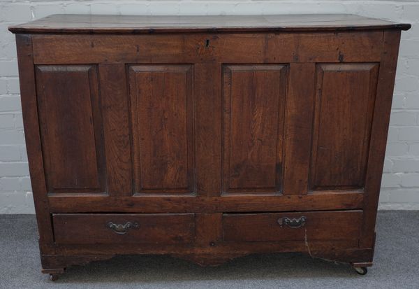 A mid 18th century oak mule chest, the plank top over four panel front and pair of drawers, 125cm wide x 93cm high x 53cm deep.