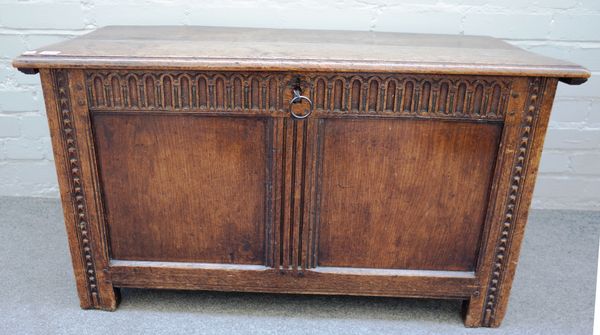 A 17th century oak coffer, the double plank top over twin panel front on stile feet, 97cm wide x 56cm high x 47cm deep.