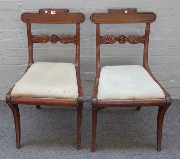 A set of six Regency mahogany framed roll back dining chairs with bullseye waist rail on sabre supports, 49cm wide x 84cm high.