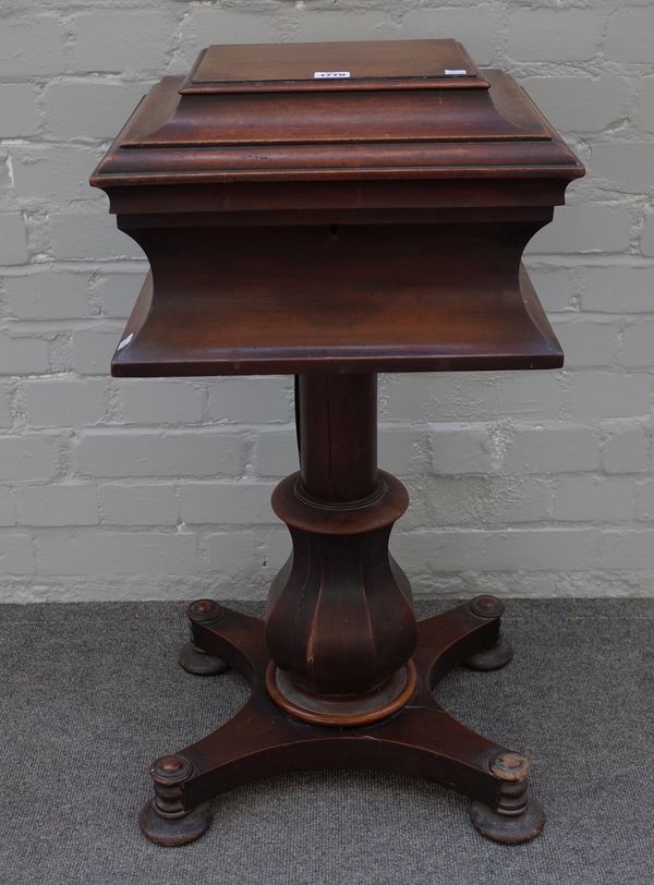 A William IV mahogany teapoy, the hinged rectangular top on octagonal baluster column and quatrefoil platform, 41cm wide x 82cm high x 37cm deep.