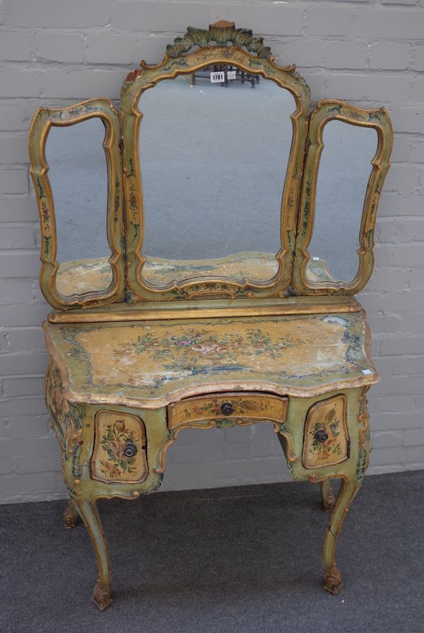 An early 20th century Italian polychrome painted dressing table with triptych mirror over a bombe base with single drawer and pair of cupboards on cab