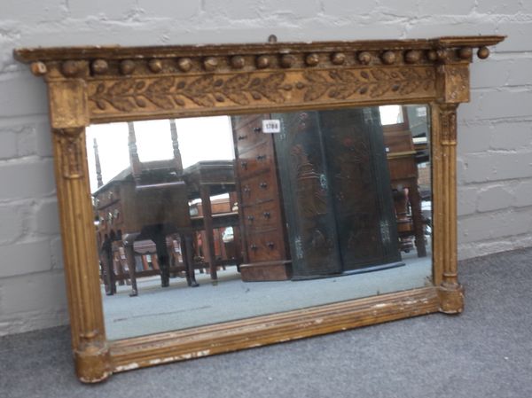 A small Regency gilt framed overmantel mirror with ball mounted frieze and reeded columns, 92cm wide x 57cm high.