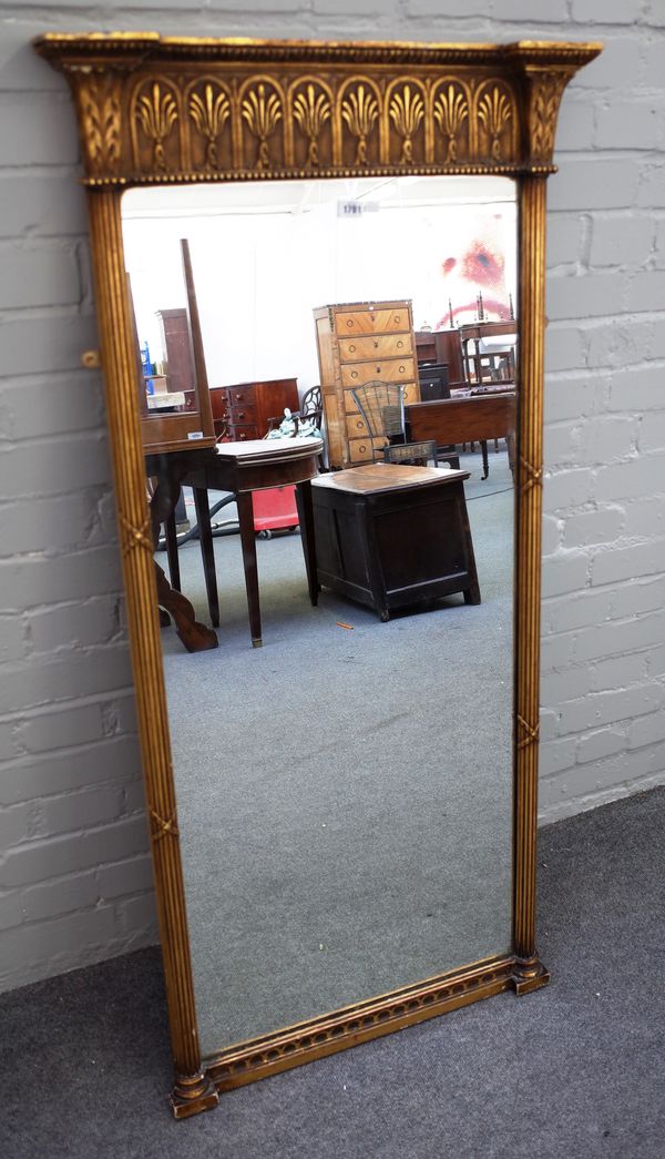 A Regency style gilt pier glass with ribbon tied reeded frame, 65cm wide x 137cm high.