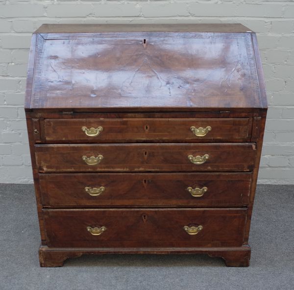 A George II figured walnut feather banded bureau, the fitted interior over four long graduated drawers on bracket feet, 92cm wide x 98cm high x 50cm d