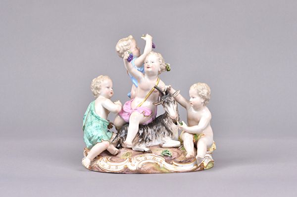 A Meissen porcelain allegorical figure group, late 19th century, emblematic of Autumn, depicting four putto around a goat, holding grapes and vegetabl