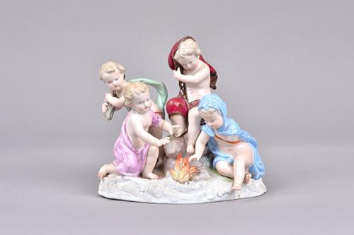 A Meissen porcelain allegorical figure group, late 19th century, emblematic of Winter, depicting four putto around a fire, on a snow covered shaped ba