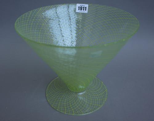 A Continental green glass footed bowl of conical form early 20th century, with two tone green/yellow line decoration and raised geometric detail, 20.5