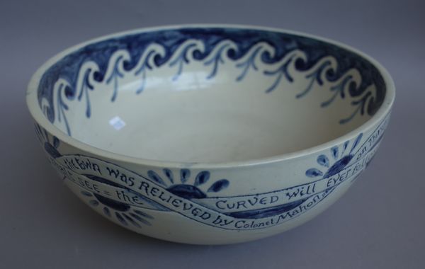 An unusual blue and white pottery bowl of large proportions, circa 1900, detailed with banded verse and originally made for a set of bedroom ware for