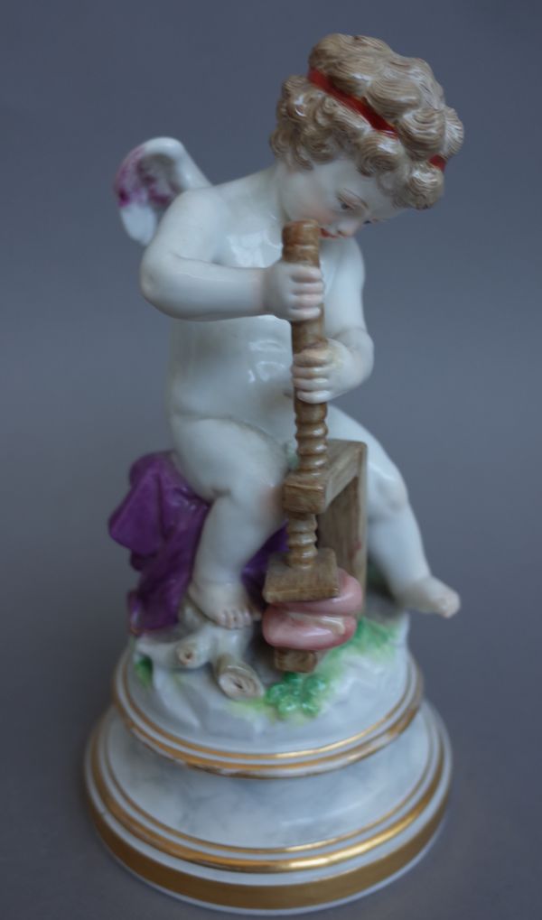 A Meissen porcelain figure, early 20th century, depicting Cupid crushing hearts in a wooden vice, raised on a circular marbled base, cancelled blue cr