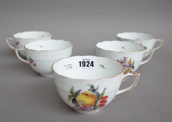 Five large Herend porcelain tea cups and six matching saucers decorated with fruit and forest flowers No 701, blue printed marks; a Meissen 'Onion' pa