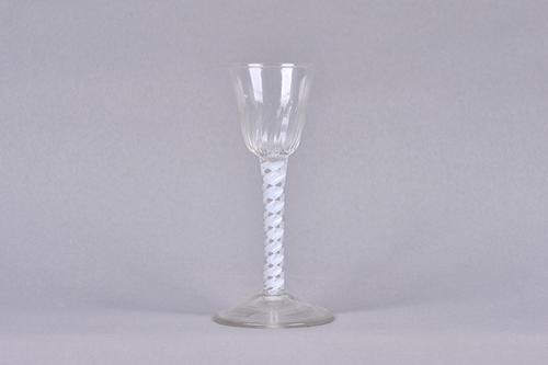 An opaque twist wine glass, circa 1765, the moulded rounded funnel bowl raised on a double-series opaque twist stem and plain foot, 15cm.high. Illustr