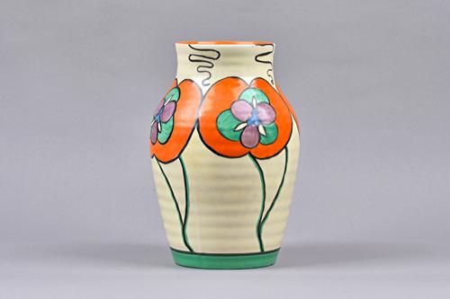 A Clarice Cliff 'Orchid' Latona form vase, Circa 1930, decorated with large orange flowers against a ribbed cream ground, black printed marks, 24.5cm