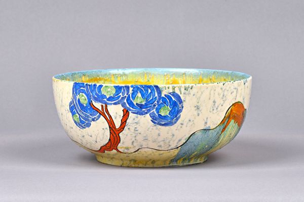 A Clarice Cliff Bizarre 'Patina Blue Tree' bowl, circa 1931, black printed marks and stamped 'Provisional Patent 23385', 21cm dia. Illustrated