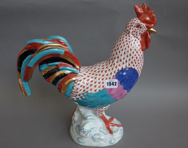 A large Herend porcelain cockerel, decorated in a red and gilt Imari pattern raised on a naturalistic base, blue printed mark, incised 5030/10 and sta