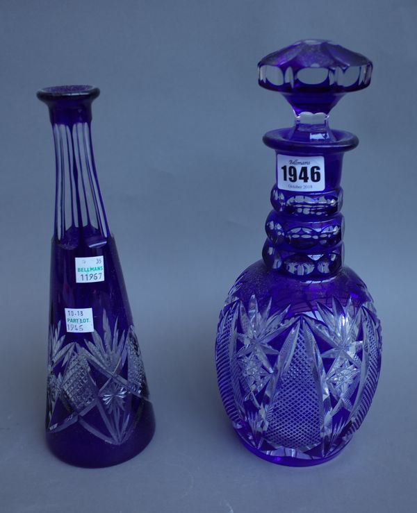 A Baccarat style blue flashed glass cut glass decanter and stopper, 28.5cm high, and a French 'Nancy' crystal blue flashed cut glass decanter, (2).