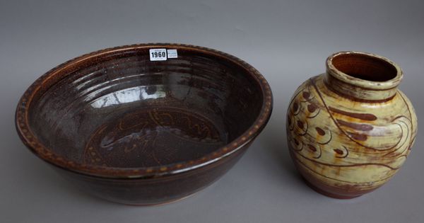 A large stoneware bowl in a tenmoku type glaze (37cm diameter), a small green glaze earthenware bowl of conical form (10.5cm diameter), a tall stonewa