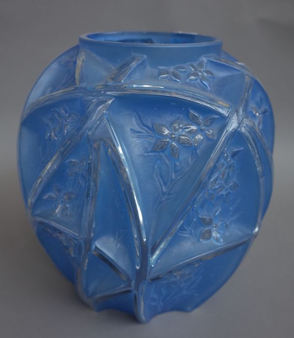 A Lalique style blue glass vase, 20th century, moulded with flowers against an ovoid ground, 27cm high.