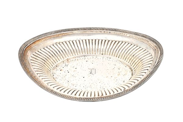 A late Victorian silver dish, of oval form, with partly fluted decoration within a gadrooned rim, Sheffield 1896, length 28.5cm, weight 398 gms. Illus