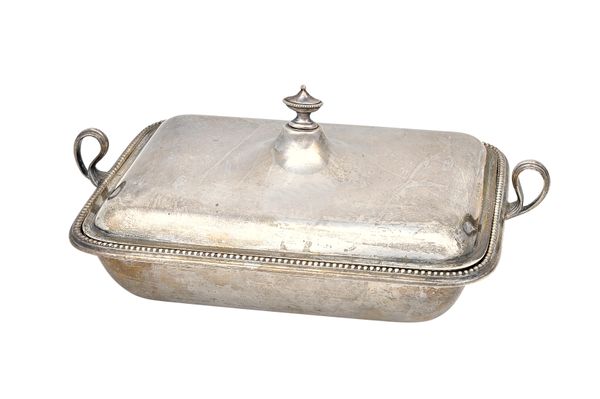 A silver twin handled lidded entree dish, the base decorated with a beaded rim, the lid with an urn form finial and with a drop-in silver liner, by Go