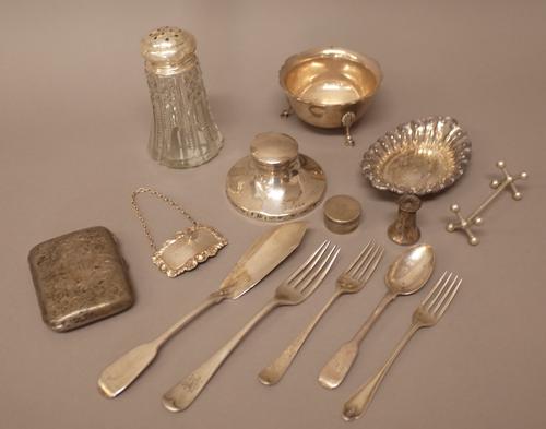 Silver and silver mounted wares, comprising; a sugar bowl, London 1912, a circular small inkstand, an oval trinket dish, a faceted glass sugar caster,