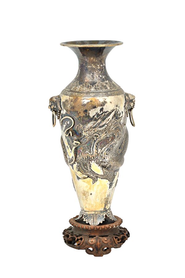 A Chinese vase, of baluster form, the body decorated with a dragon and with two dragon mask and ring handles, raised on a foliate foot, height 18.5cm,