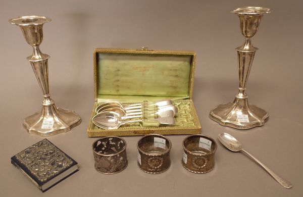 Silver and silver mounted wares, comprising; a pair of silver candlesticks, each raised on a shaped oval base, height 18cm, (loaded), six fiddle patte