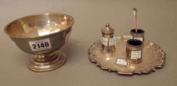 A silver bowl of panelled circular form, Sheffield 1918, weight 96 gms and three plated condiments with one spoon, with a stand decorated with a pie c